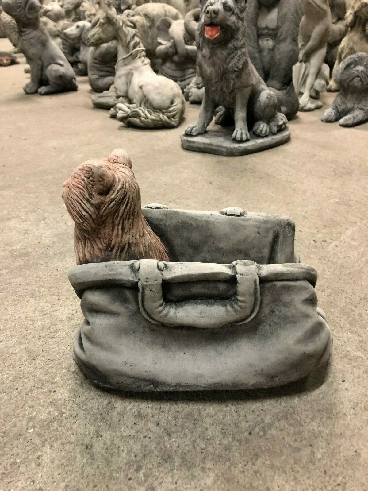 Limestone-finished Cat In Bag Planter showing side view of sculpted cat in a textured stone handbag, a charming garden animal ornament.