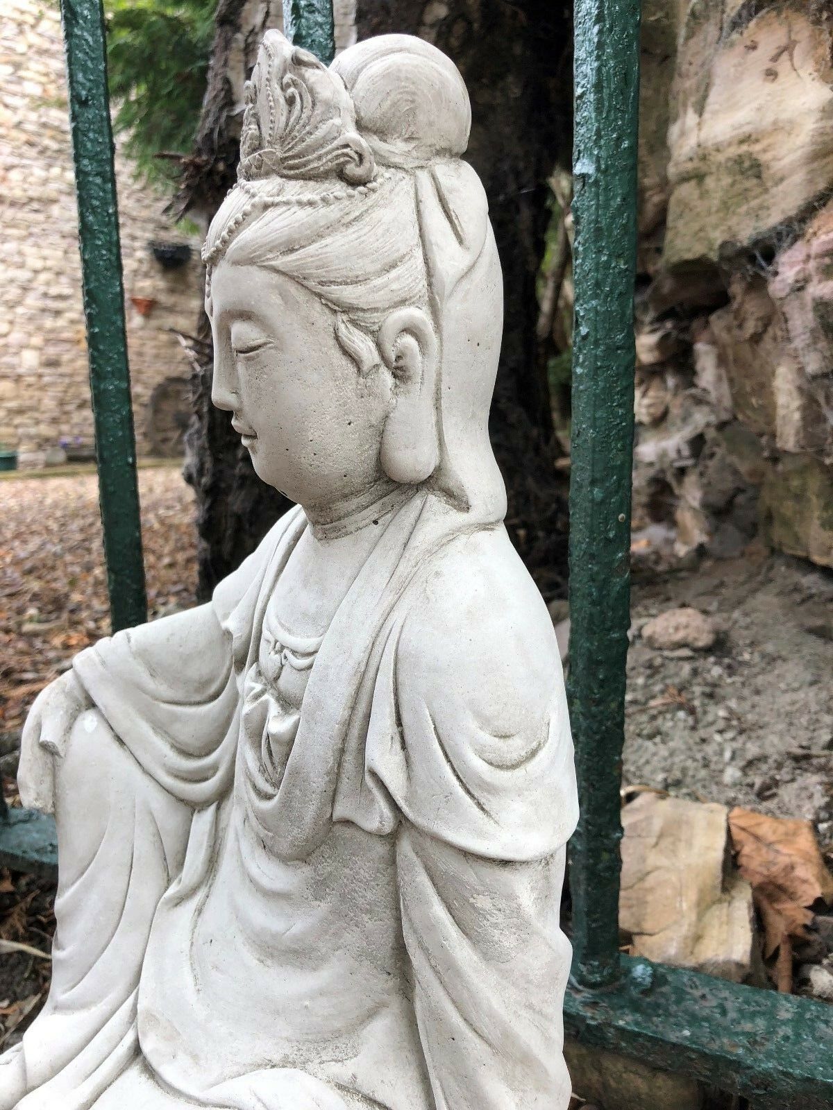 Side profile of Kuan Yin garden statue in limestone, highlighting elegant robe details. Ideal for Buddhist or feng shui garden themes.