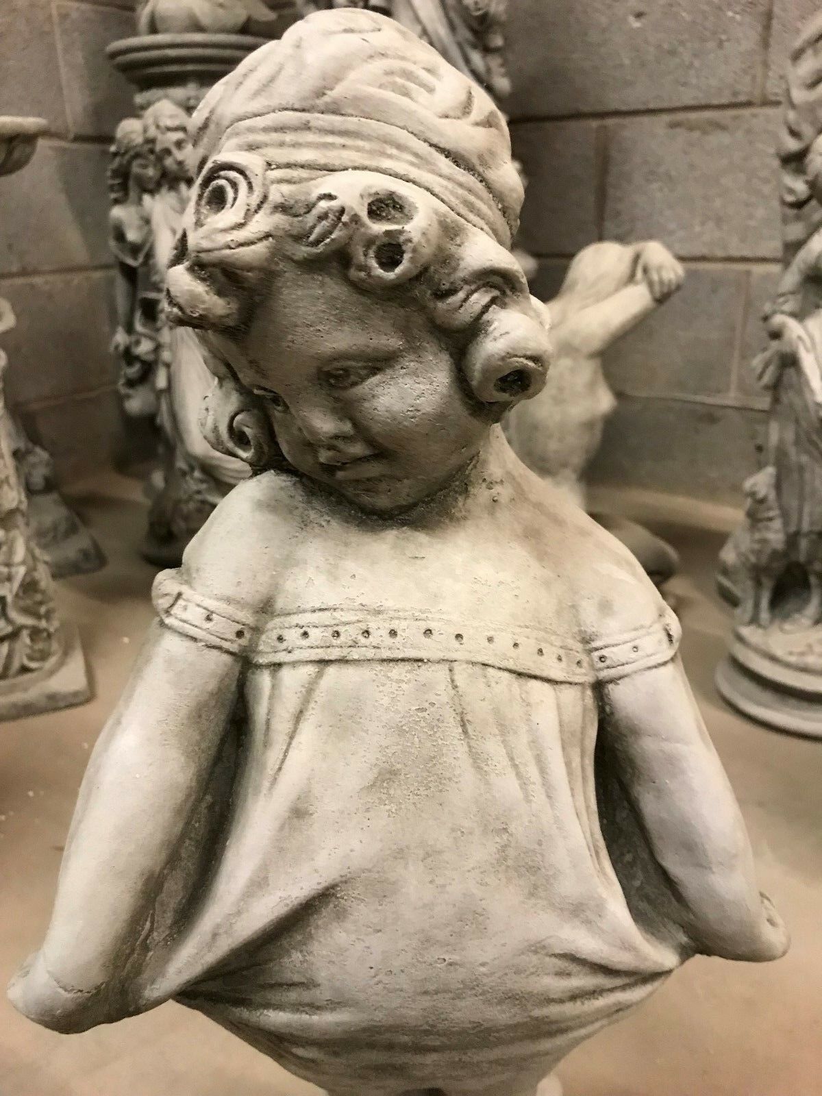 Close-up of Shy Girl Statue's face and upper body, highlighting the delicate expression and fine craftsmanship in limestone.