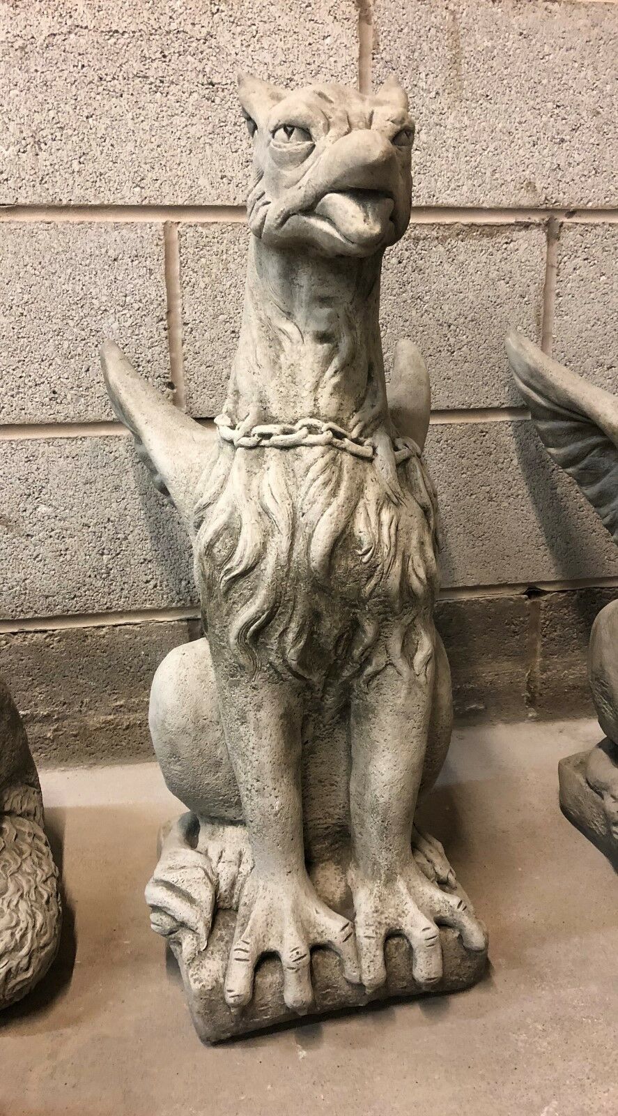 Front-facing limestone phoenix statue with fierce expression and antique grey texture, ideal for home or garden entryways.