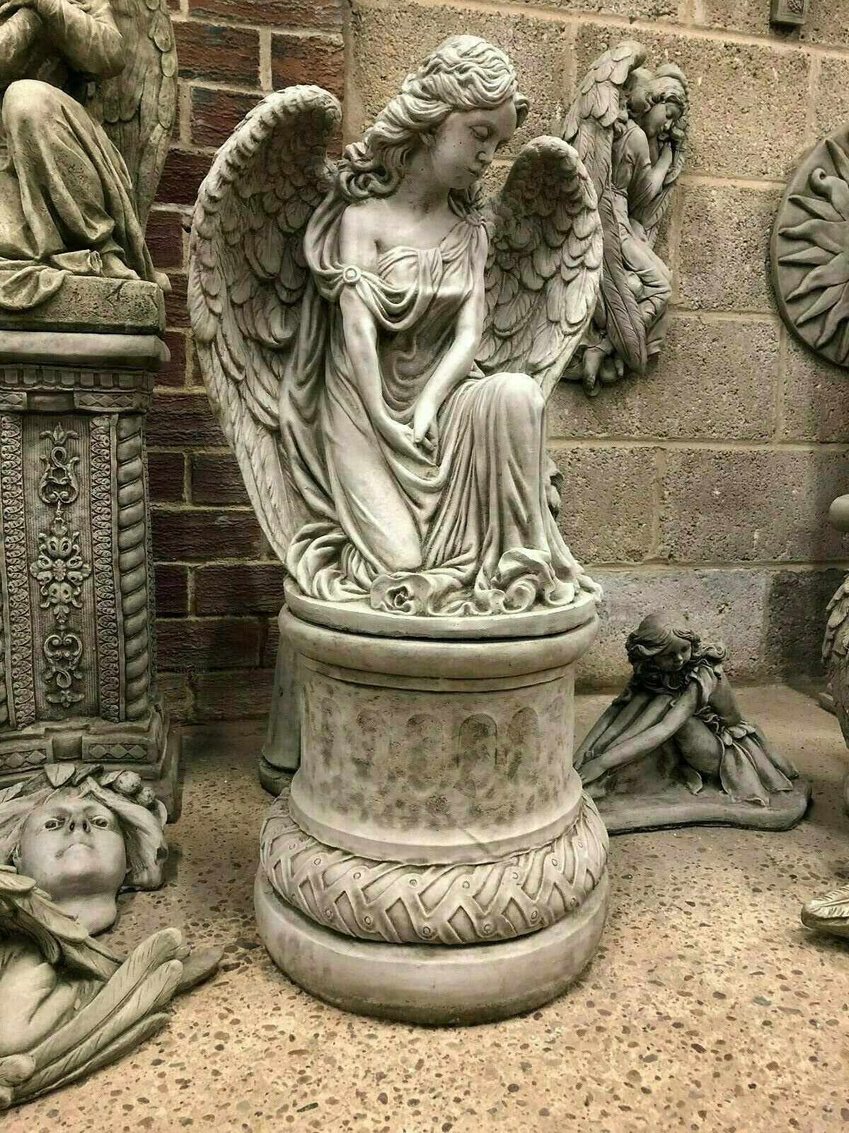 Side view of Elegant Stone Angel Garden Pedestal Statue for Landscaping. Serene angel figure with lifelike texture, ideal for patios or memorial gardens.