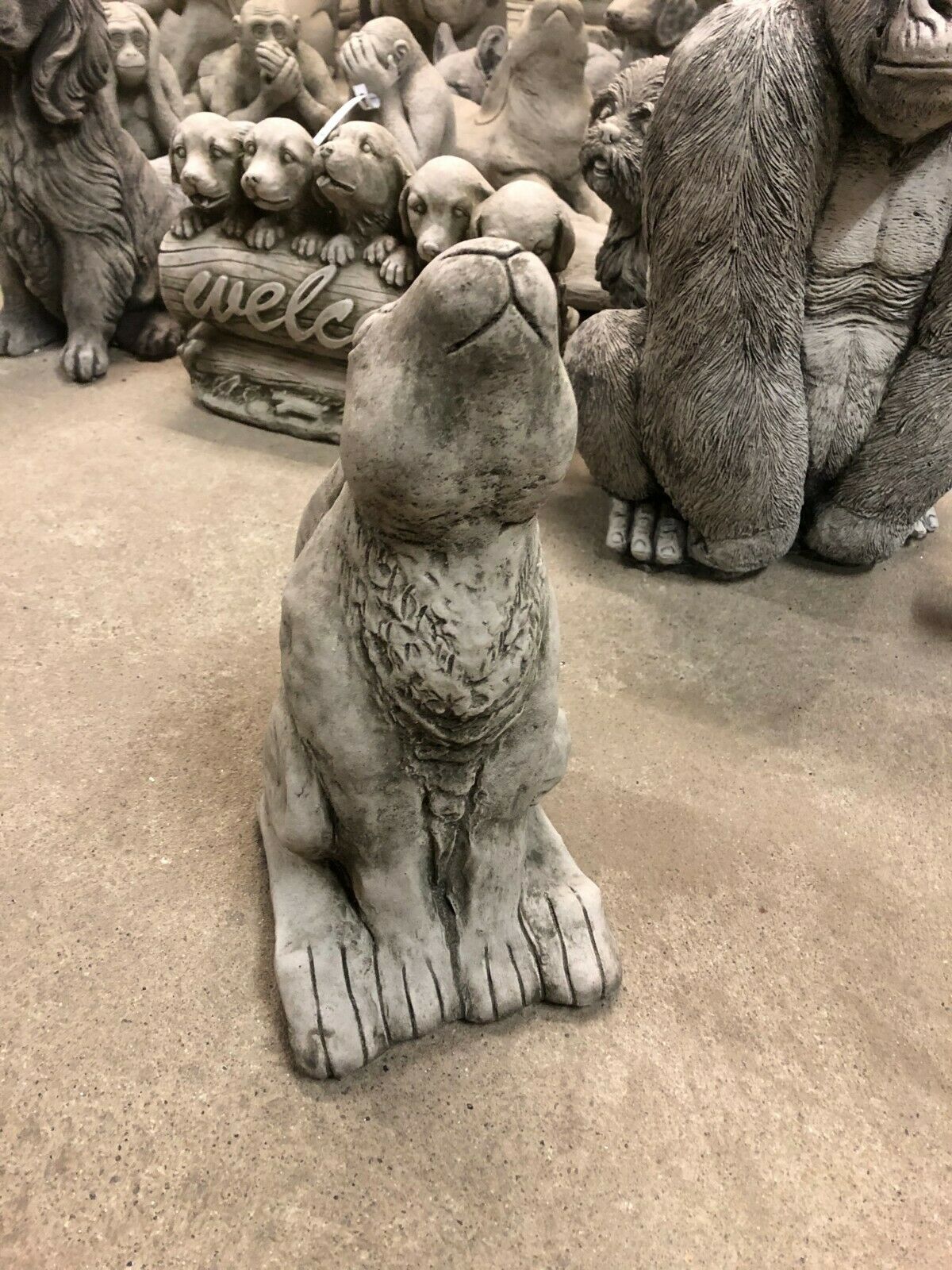 Durable Moongazing Hare Stone Statue displayed among other animal sculptures, perfect for unique garden decor and outdoor sculpture collections.