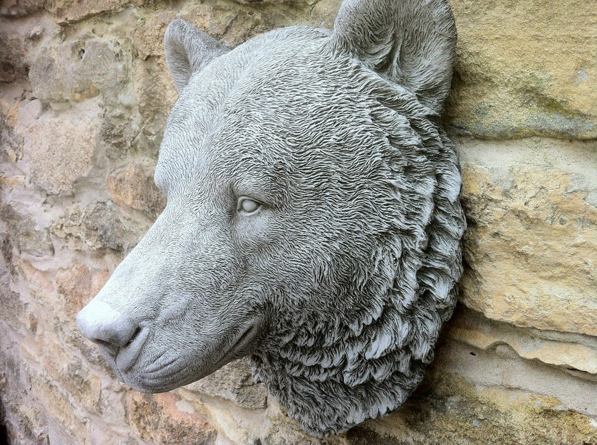 Close-up of Stone Bear Head Wall Ornament in limestone with antique finish, ideal for outdoor garden or patio wall decor.