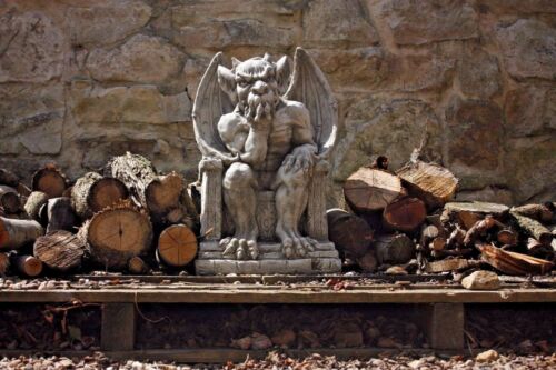 Full front view of King Gargoyle Stone Statue - Weather Resistant Garden Art in a natural setting, enhancing garden ambiance with mythical charm.