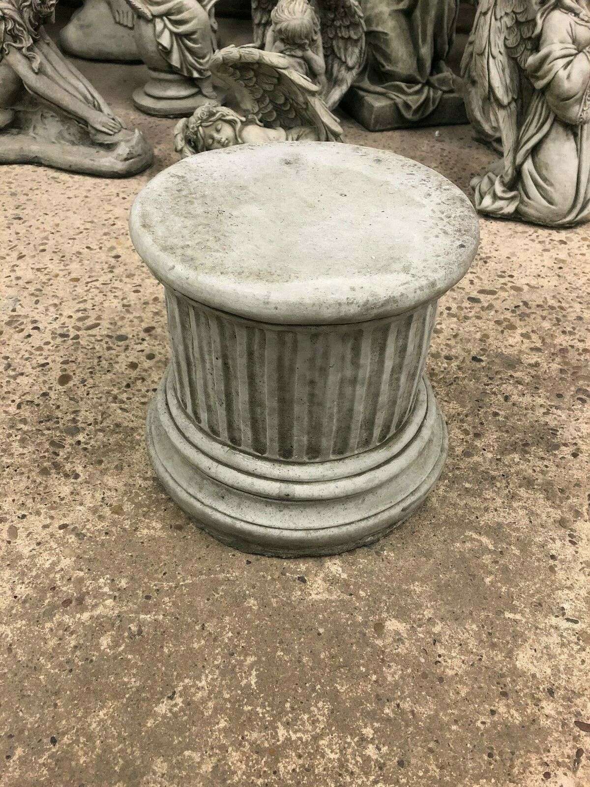 Small round stone column sculpture with fluted design, ideal as a garden plinth or pedestal for outdoor ornaments and decor.