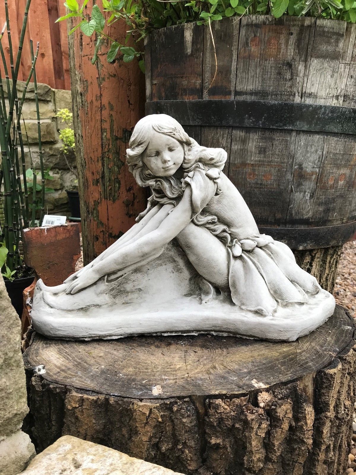 Durable limestone fairy garden ornament featuring a serene girl sculpture, ideal for outdoor decoration and weather-resistant garden art.