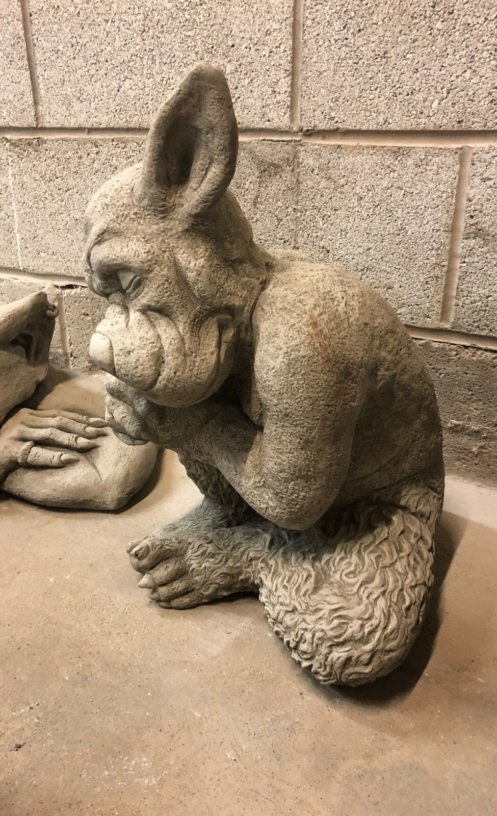 Side view of Stone Sleeping Dog Gargoyle Statue showing intricate craftsmanship and antique limestone finish for unique garden ornament appeal.