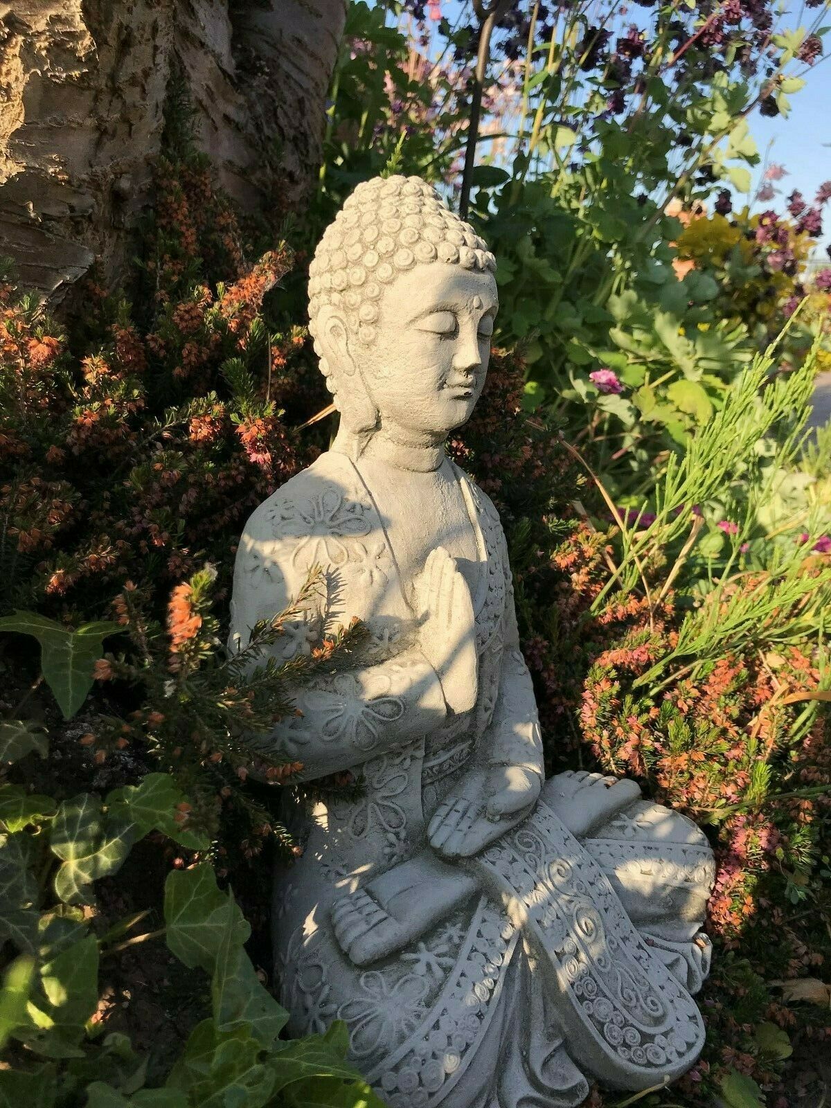 Side view of Stone Mediation Buddha Garden Statue with intricate carvings, ideal for zen-inspired outdoor spaces and patios.