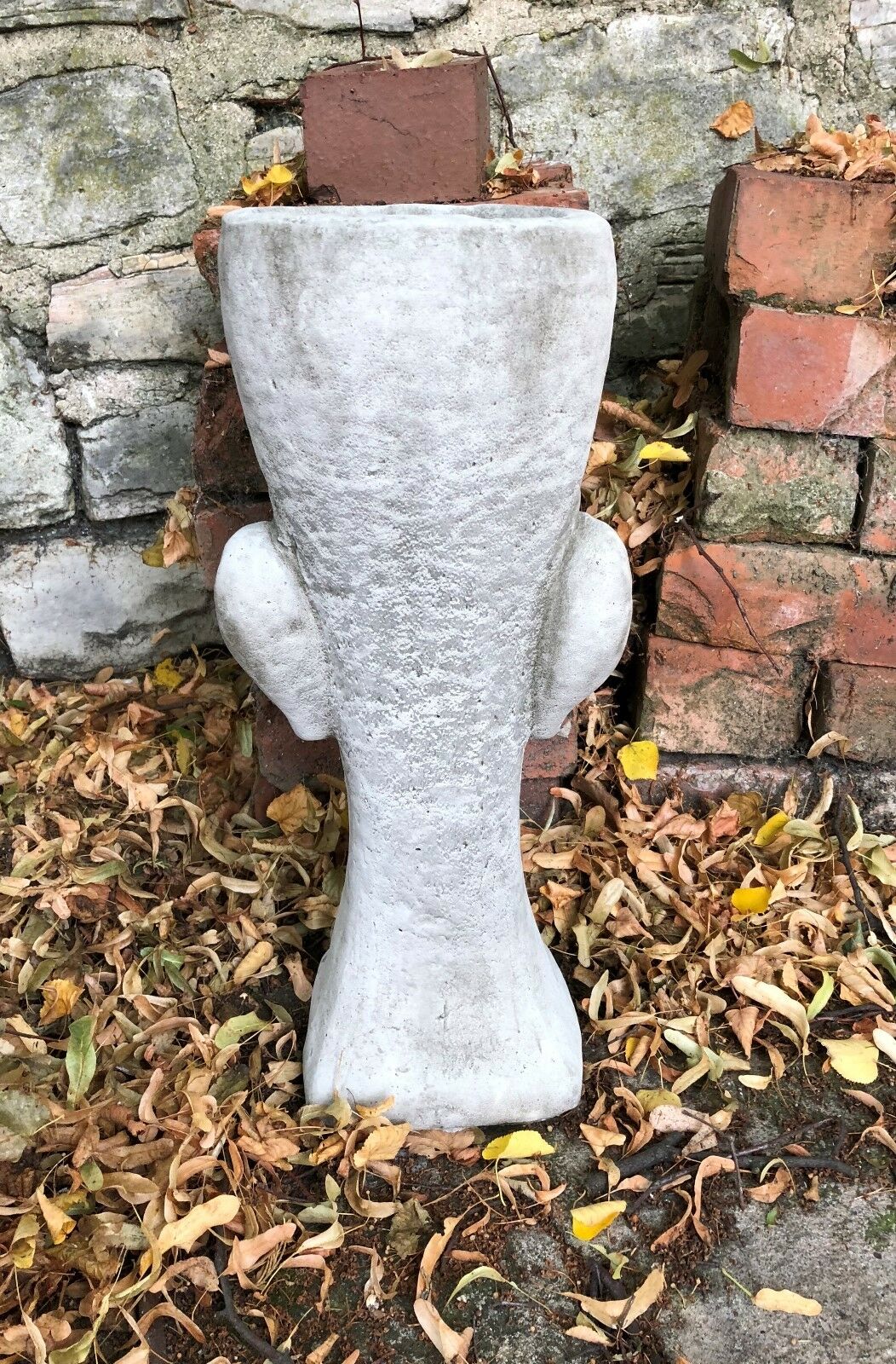 Rear view of the Stone Easter Island Head Planter revealing its solid construction and rustic finish, ideal for home and garden aesthetics.