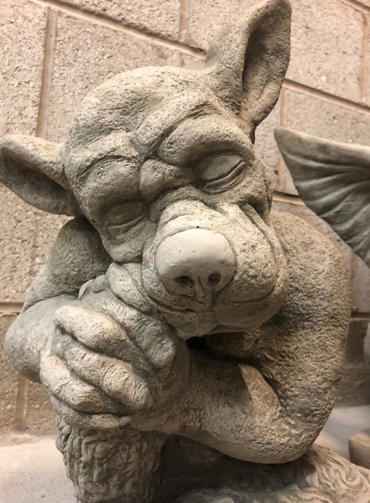Close-up of Stone Sleeping Dog Gargoyle Statue highlighting facial features and weathered stone texture for decorative garden use.