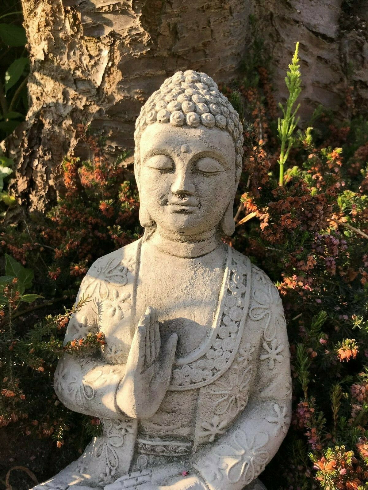 Close-up of weatherproof Stone Buddha Statue showing peaceful facial expression and detailed robe, perfect for garden tranquility.