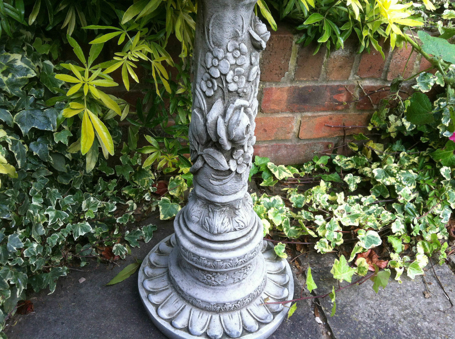 Close-up of Stone Flower Petal Design Bird Bath pedestal showing intricate floral carvings. Ideal for enhancing garden aesthetics.
