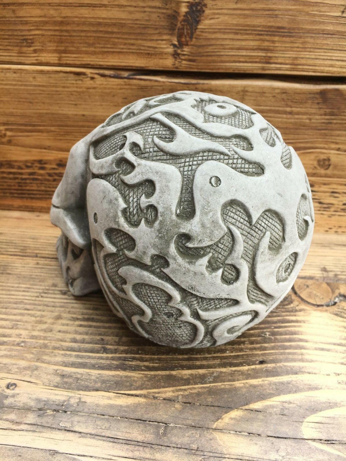 Side view of Stone Skull Garden Ornament showing elaborate textured carvings, perfect for enhancing lawn sculptures or balcony decor.