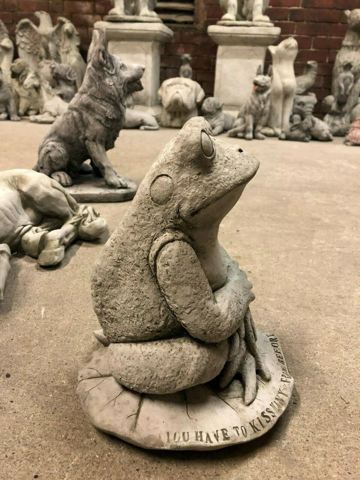 Side profile of the Stone Frog on Lilypad Ornament with realistic stone texture and humorous engraved quote, perfect for patios or flower beds.