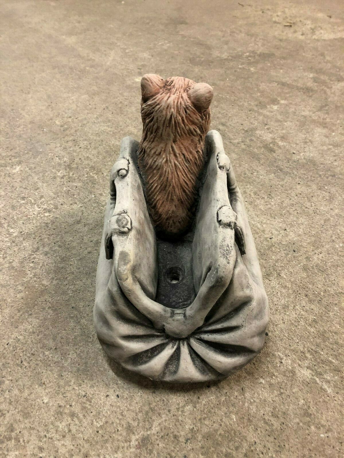 Rear view of Stone Cat In Bag Planter with visible drainage hole, showcasing durable limestone craftsmanship for outdoor plant use.