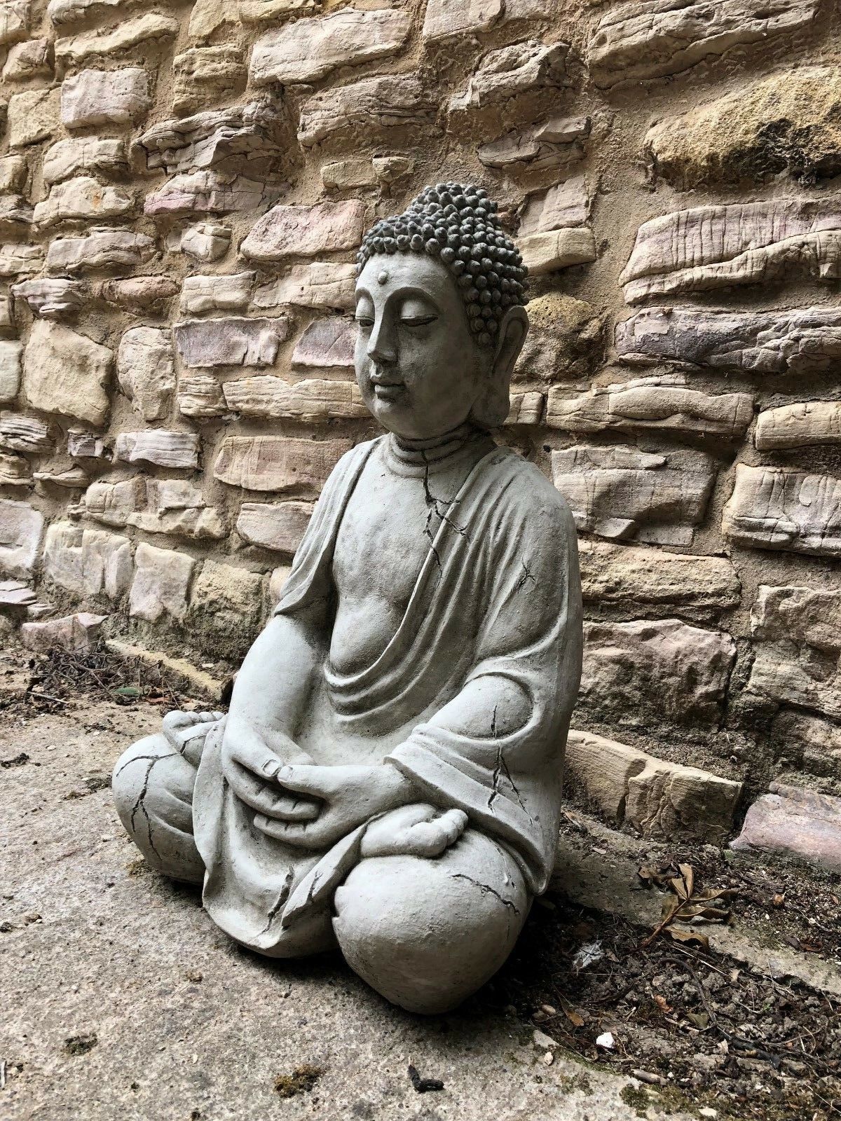 Angled view of Meditating Buddha Statue showing detailed robe folds and weathered stone effect, ideal for tranquil garden settings.