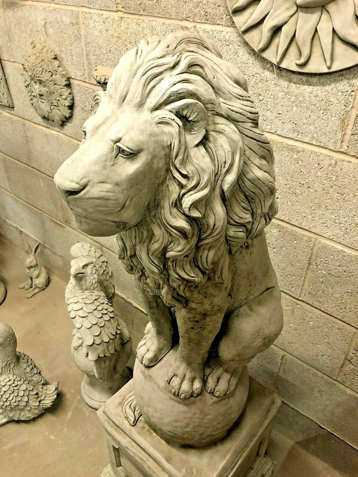 Detailed view of a lion statue's face and mane, highlighting the intricate stonework and lifelike expression for outdoor garden decor.