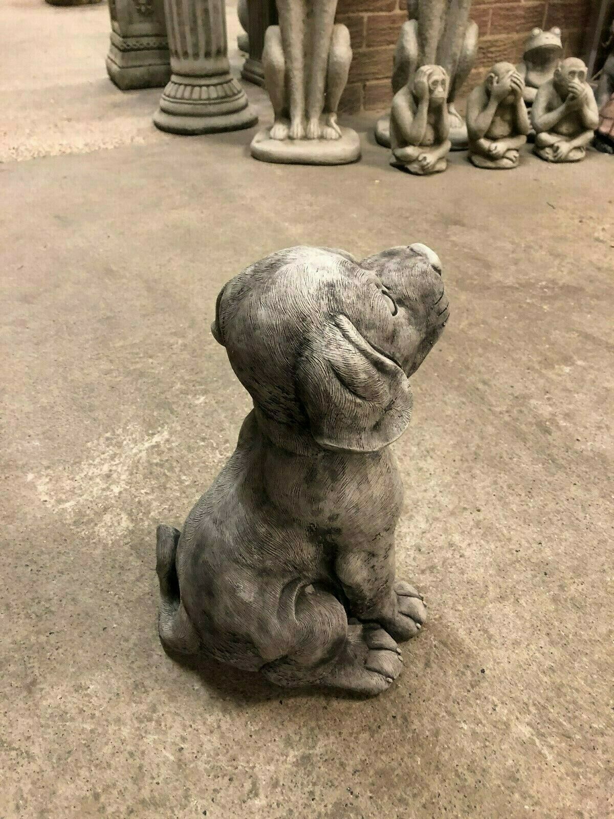 Angled back view of stone puppy ornament in antique grey, highlighting sculpted fur and sitting posture. Great for outdoor garden aesthetics.