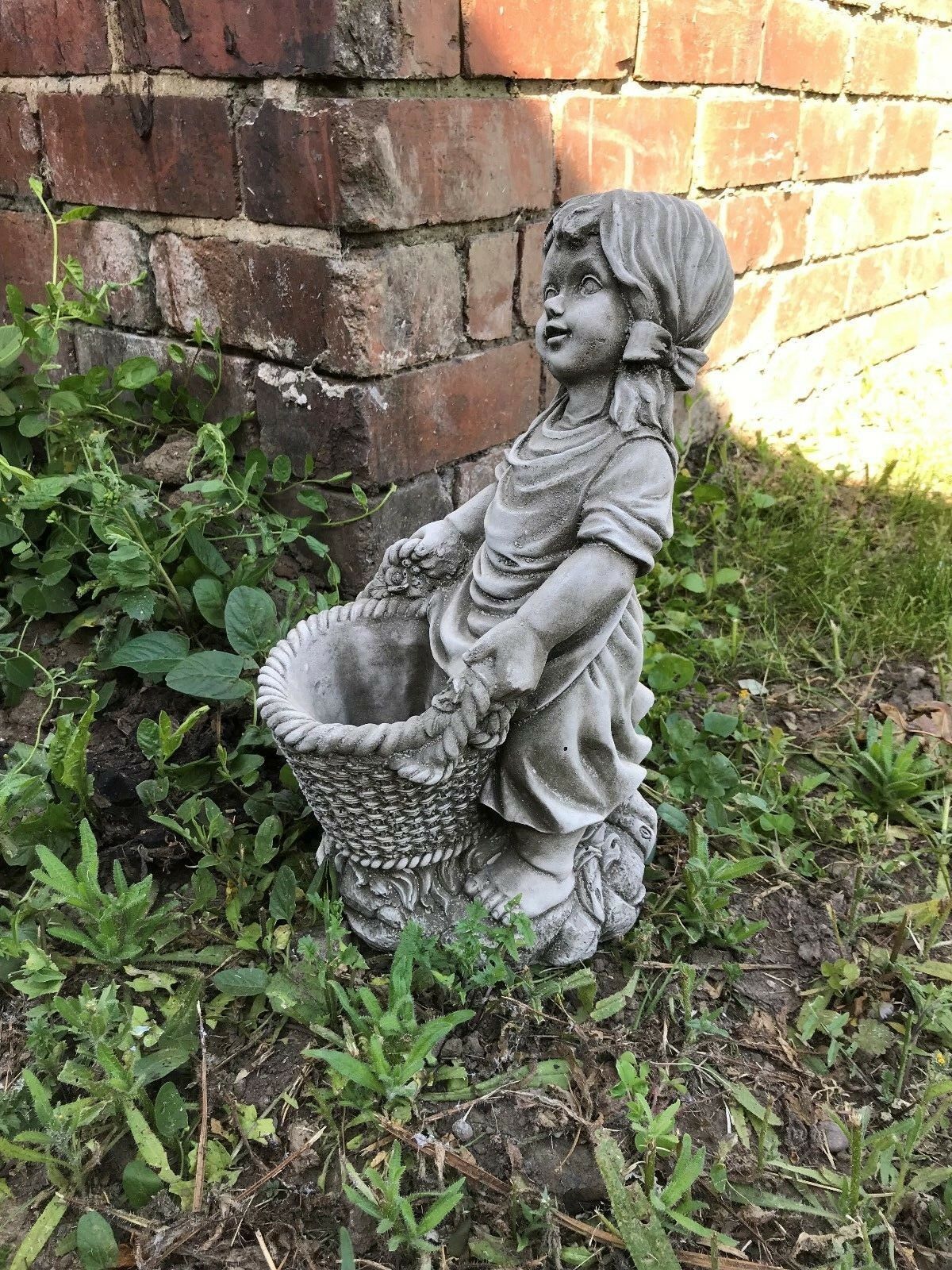 Side angle of the Stone Basket Girl Garden Planter Ornament showing textured basket and lifelike stone detailing for garden use.