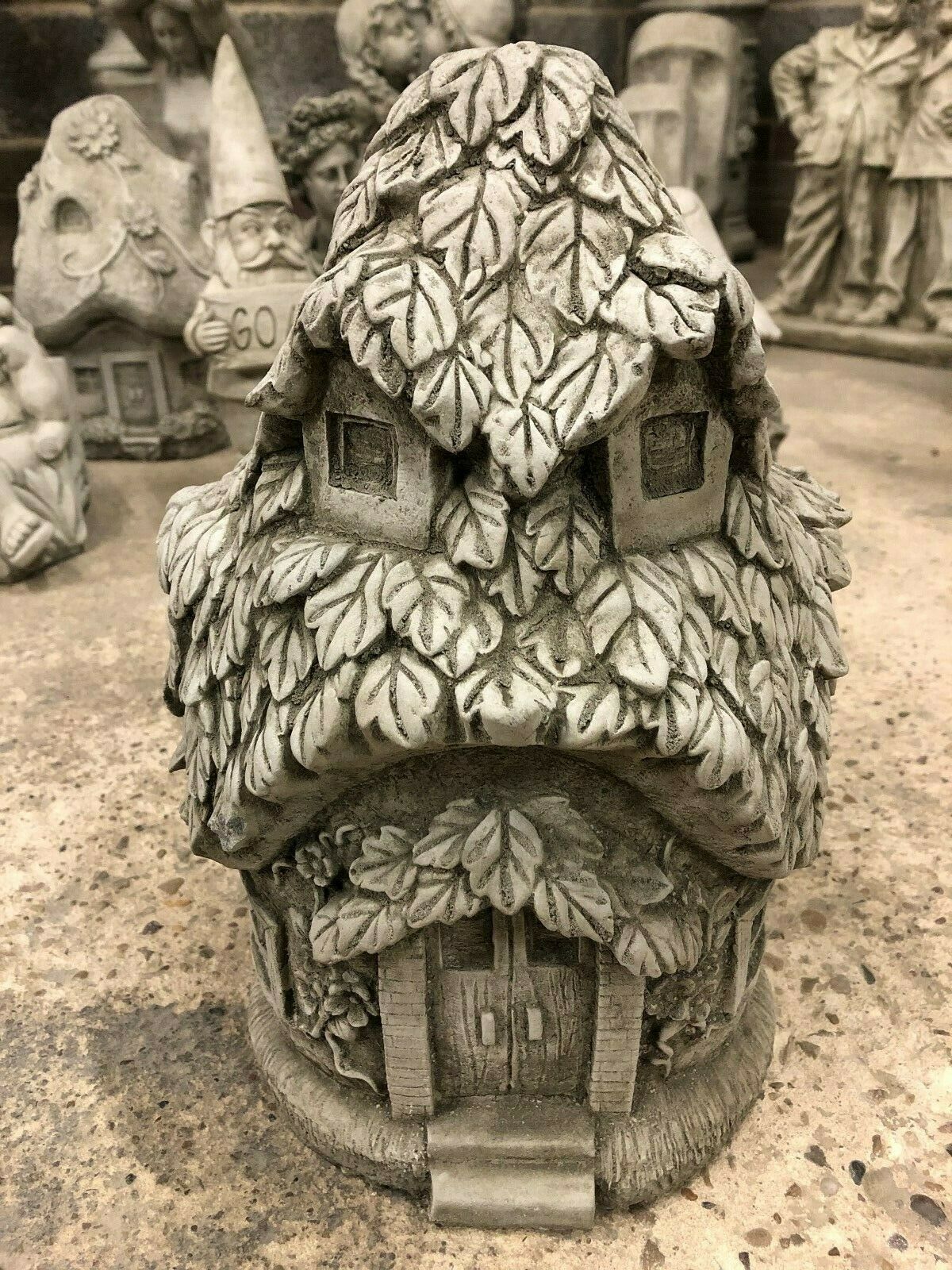 Front view of Stone Ivy Cottage Ornament - Stone Garden Ornament, featuring detailed ivy leaf texture and arched doorway for garden decor.
