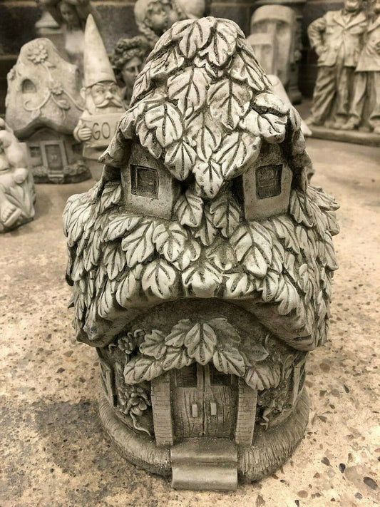 Front view of Stone Ivy Cottage Ornament - Stone Garden Ornament, featuring detailed ivy leaf texture and arched doorway for garden decor.