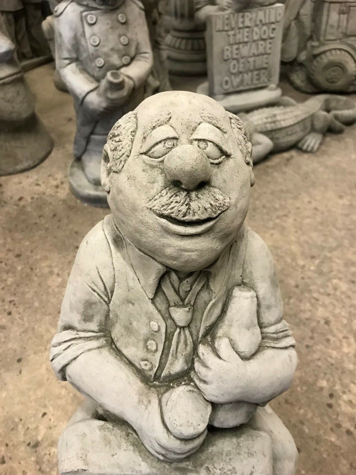 Close-up of Stone Gin Man Ornament's cheerful face and bottle detail, ideal for adding character to garden or patio spaces.