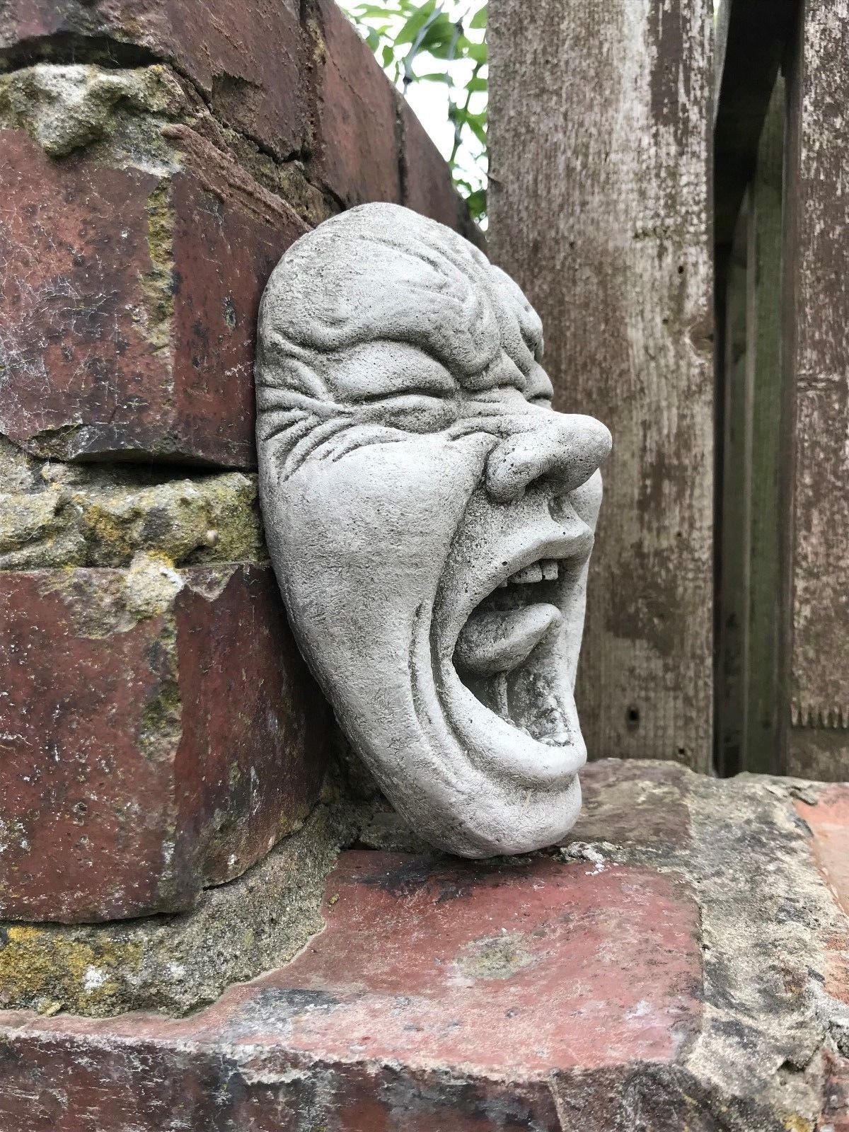 Side view of Stone Scream Face Garden Plaque showing detailed facial contours and durable limestone texture, ideal for garden wall decoration.