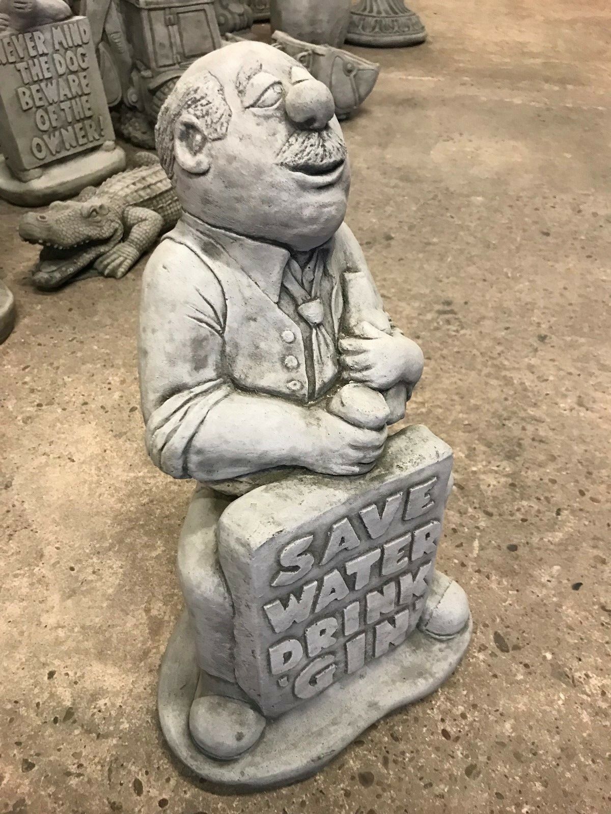 Angled view of Save Water Drink Gin Statue, a cheeky limestone garden sculpture perfect for lawn or flowerbed decoration.