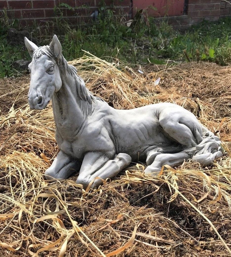Full view of Stone Resting Horse Statue - Garden Ornament in outdoor setting, ideal for lawn or flowerbed decoration.