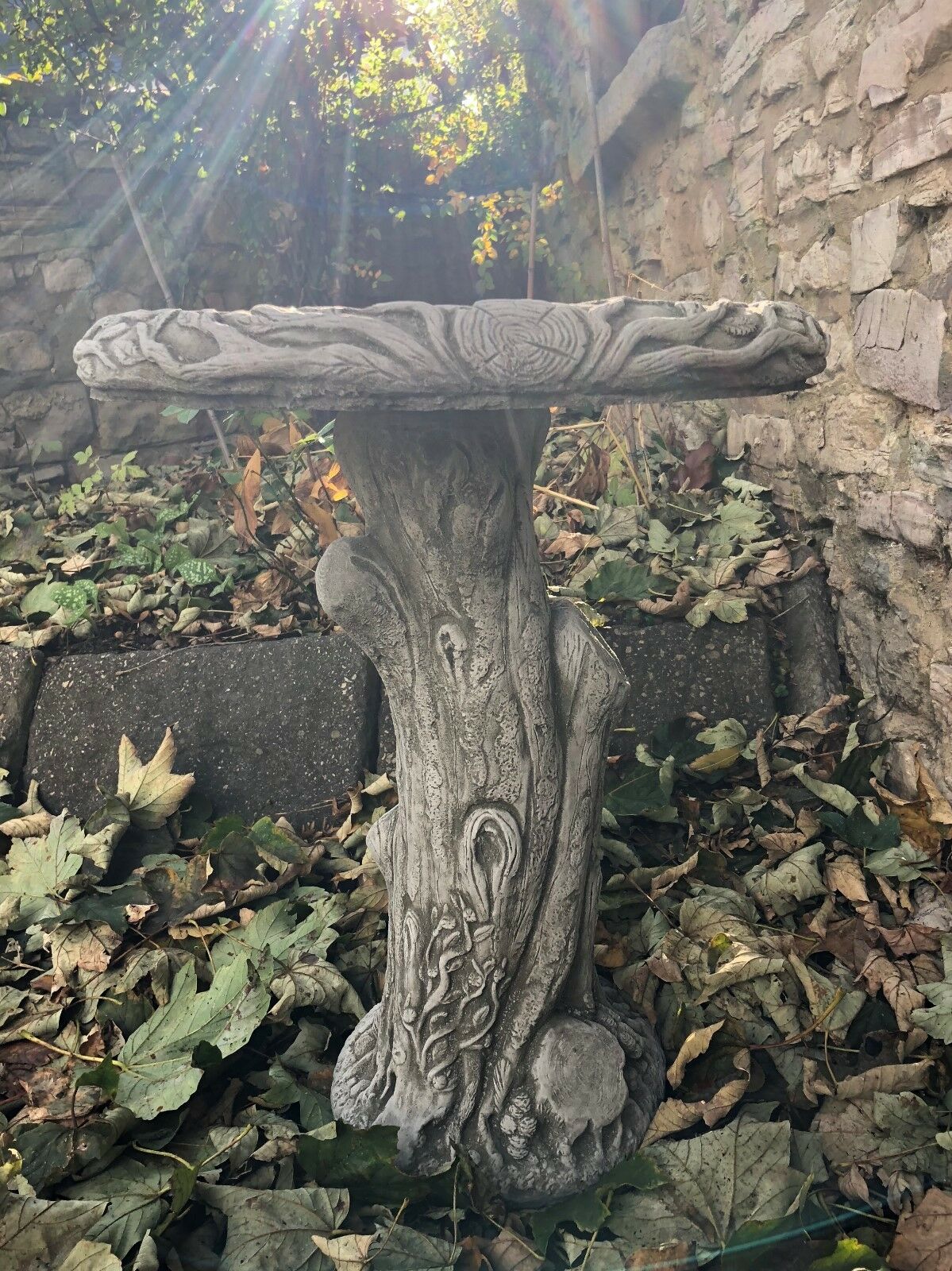 Stone Garden Bird Bath featuring a realistic tree trunk base and wide bowl, perfect for attracting birds to your patio or garden.