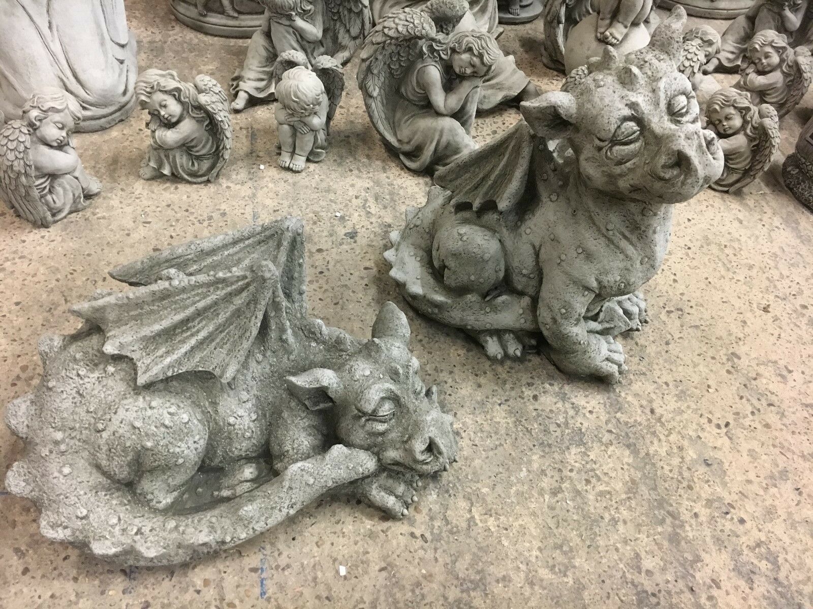 Dragon garden statues - stone baby pair with weatherproof antique texture, perfect for patios or flowerbeds in whimsical garden settings.