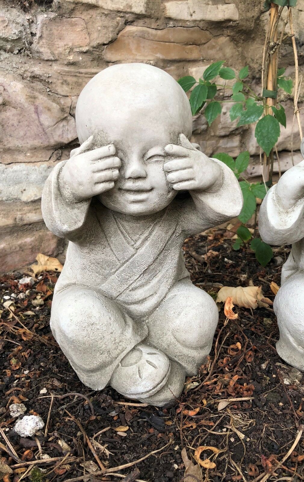 Close-up of 'See No Evil' Baby Monk Ornament with hands covering eyes, detailed stone finish ideal for garden decoration.