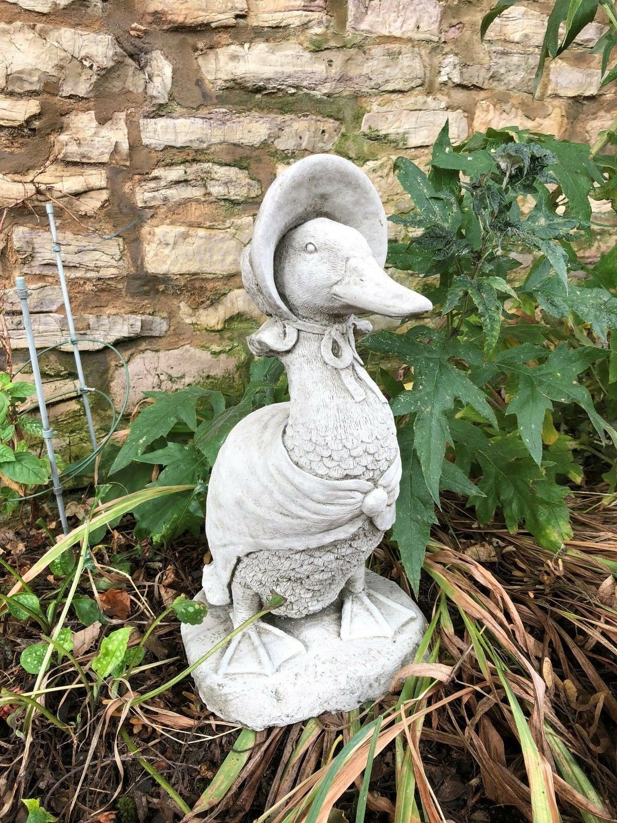 Front-facing view of Jemima Duck garden sculpture with bonnet and shawl. A durable and decorative lawn ornament for home gardens.