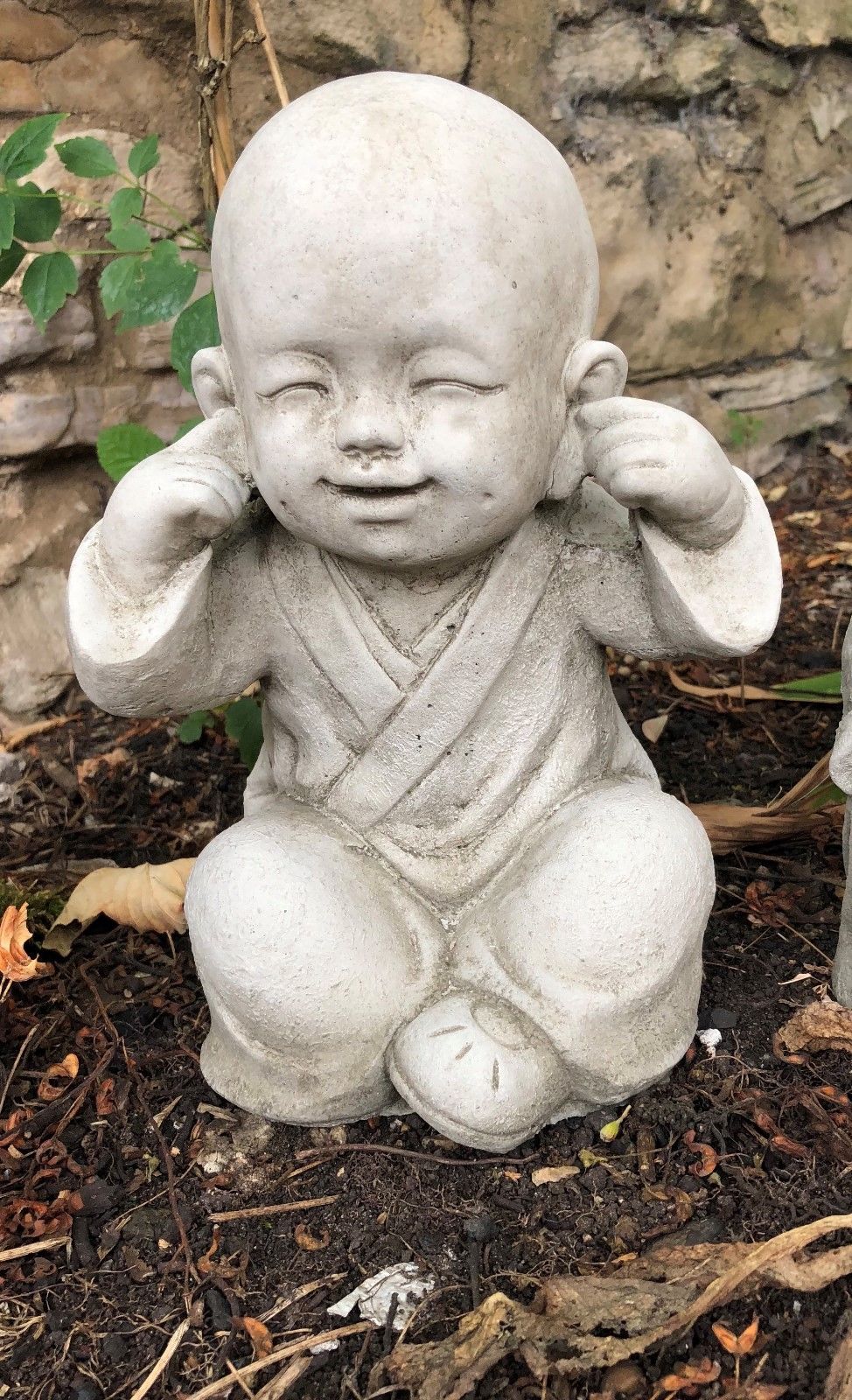 Detailed view of 'Hear No Evil' Baby Monk Ornament with hands over ears, crafted in durable stone for outdoor use.