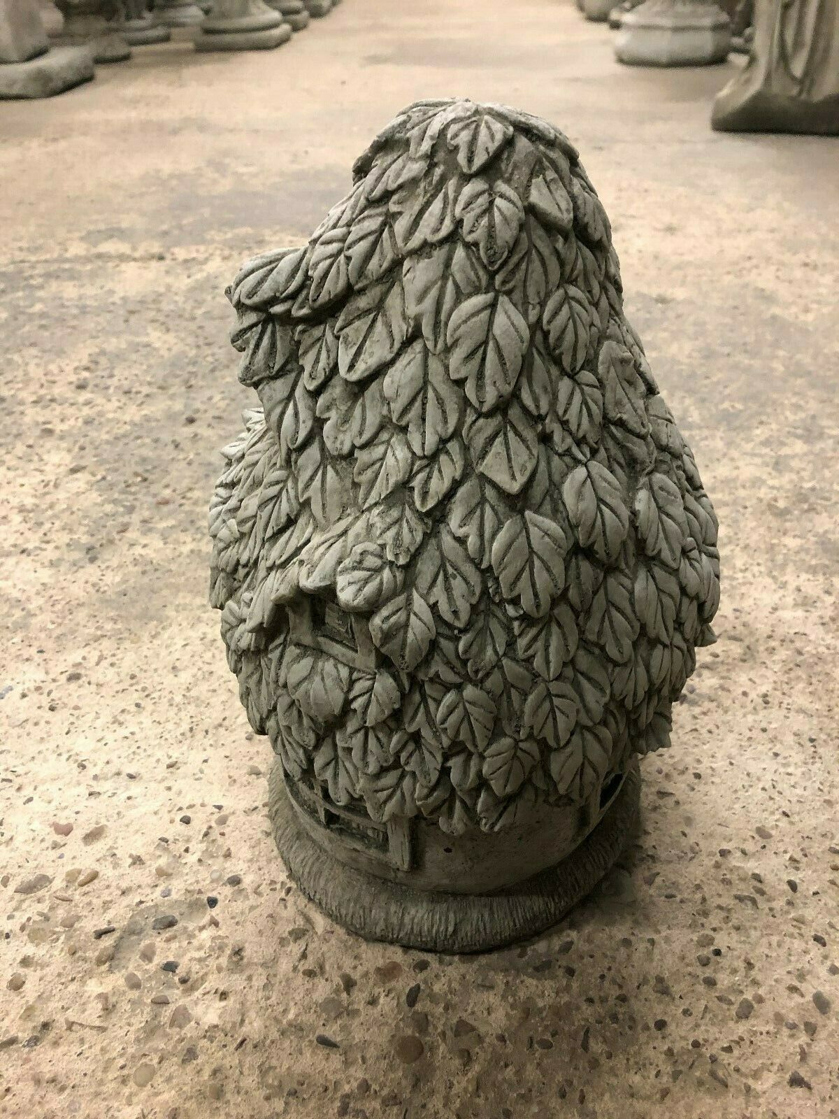 Side angle of Stone Ivy Cottage Ornament showing layered ivy leaf design and small window, ideal for whimsical garden decoration.