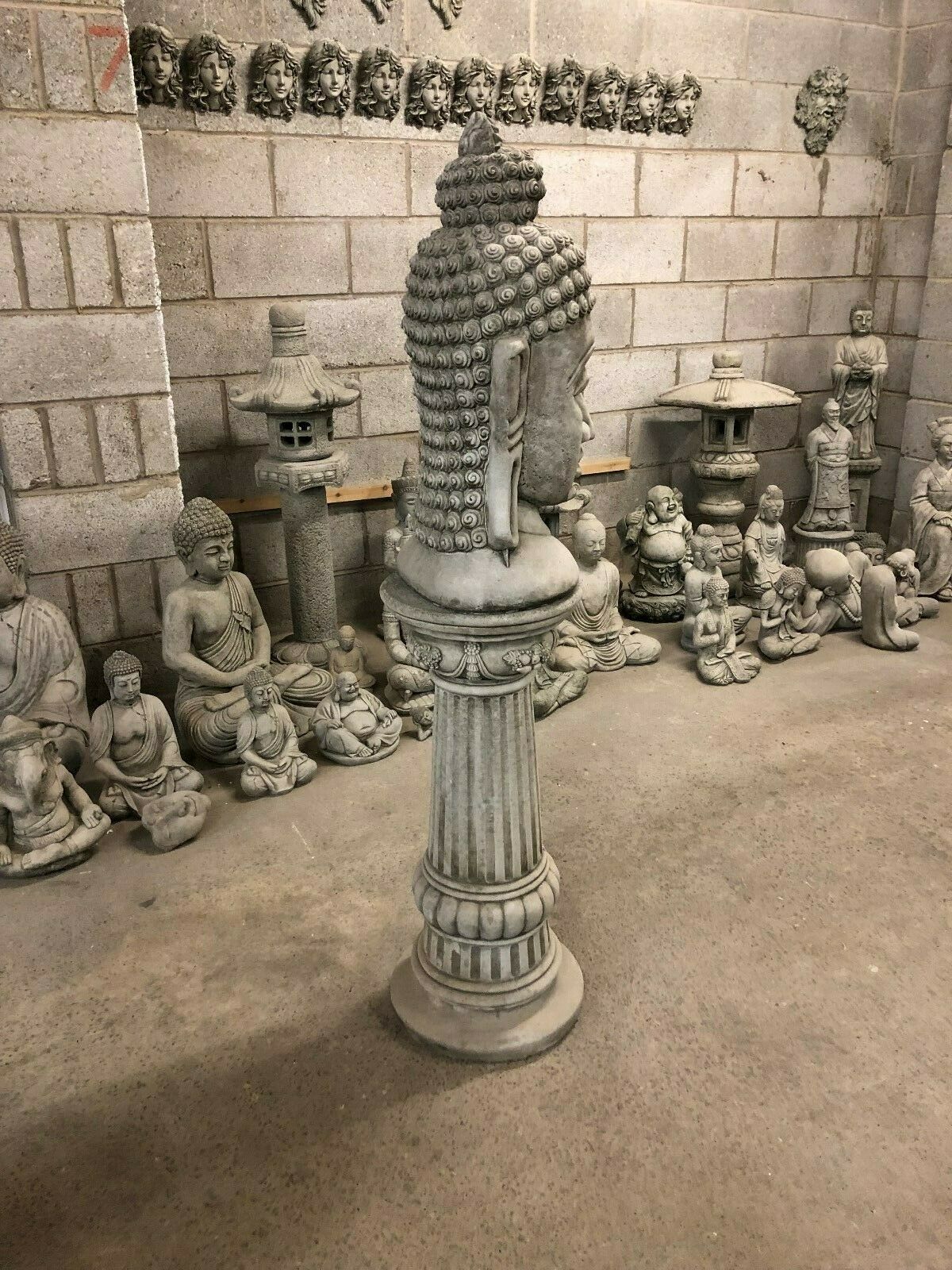 Rear view of Buddha Head Garden Statue showing detailed hair curls. Solid stone construction suited for outdoor garden decor.