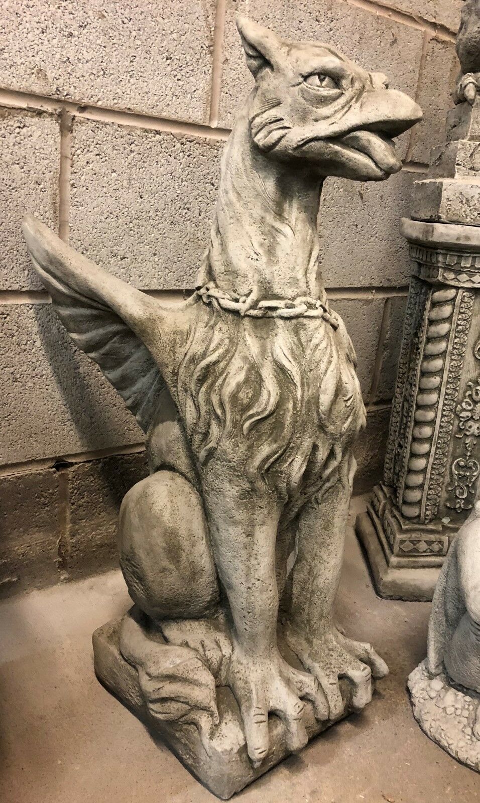Limestone phoenix statue in antique grey finish, seated on stone base with lifelike feathers and guarding posture.
