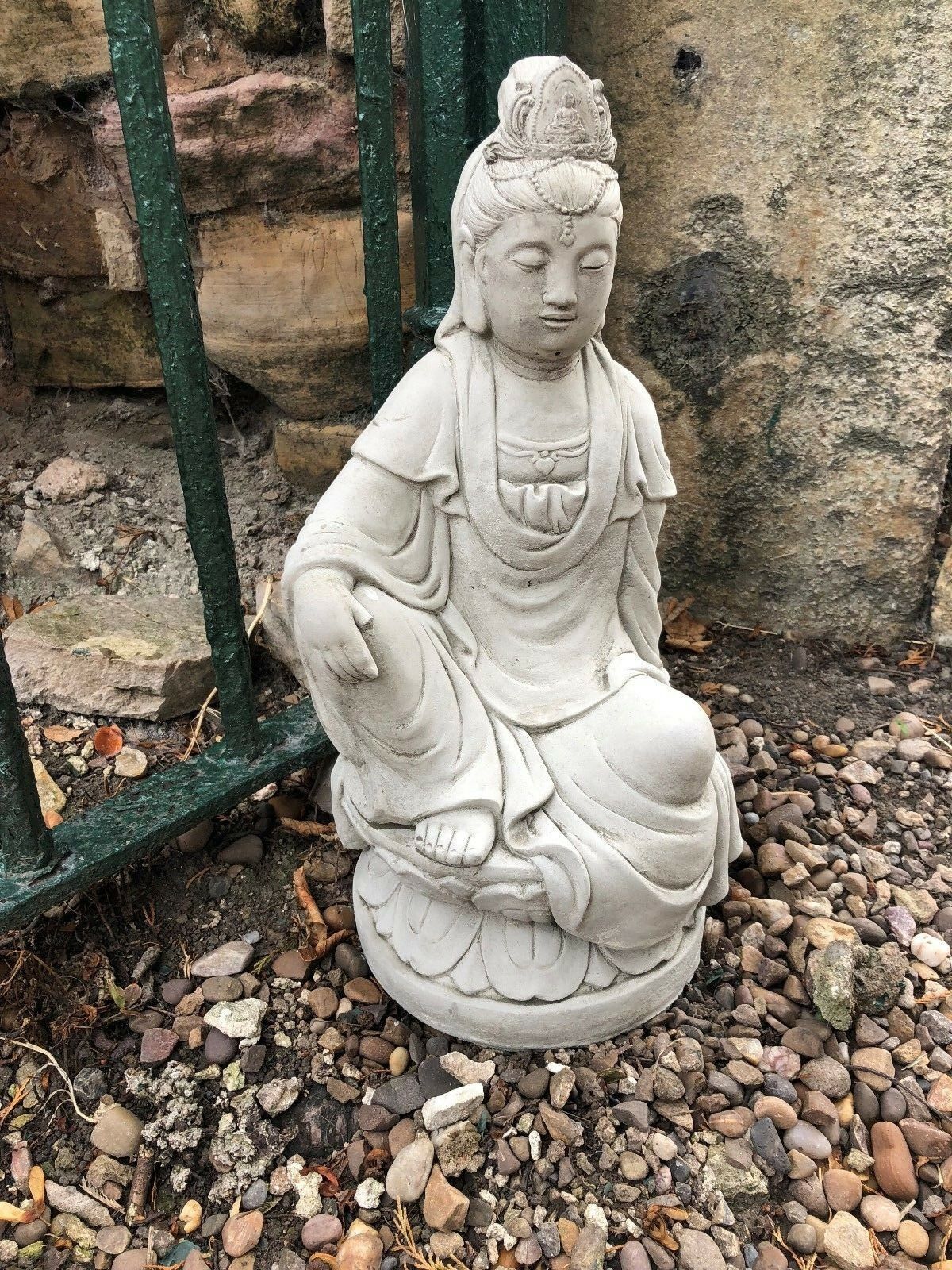 Front view of Kuan Yin statue in stone, kneeling on lotus base. Elegant 18" garden sculpture for decorative outdoor spaces.
