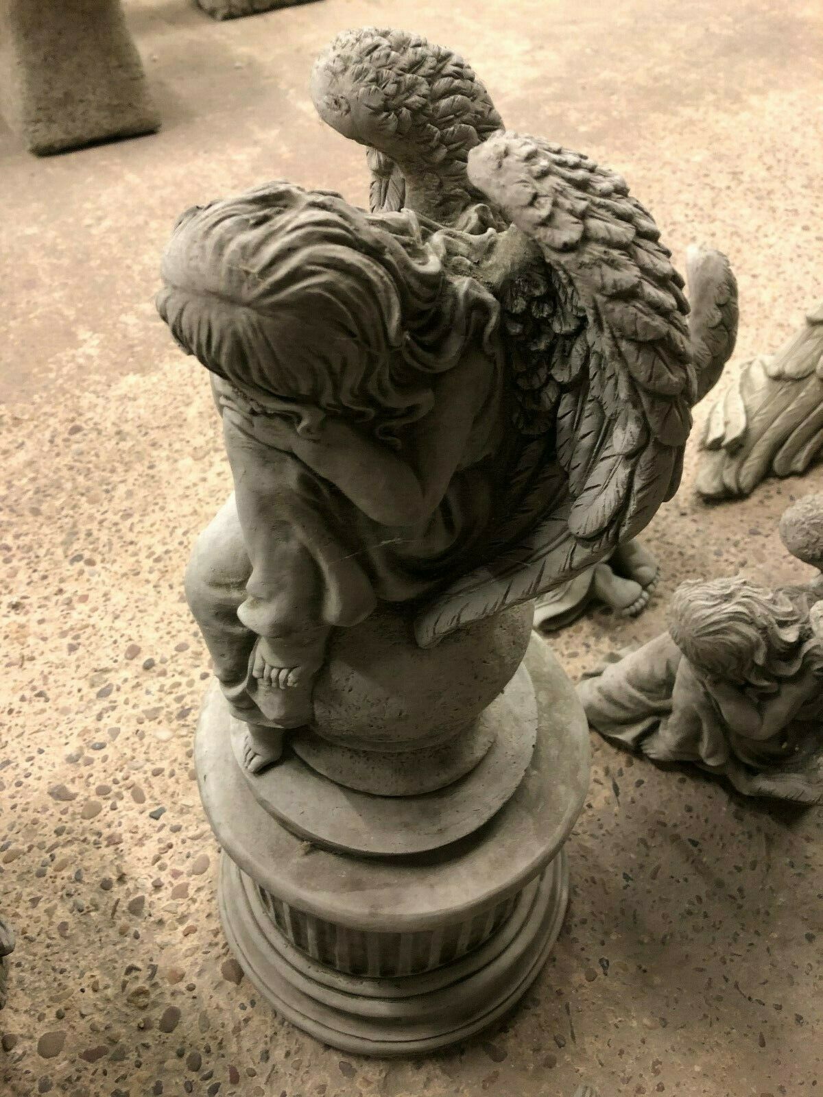 Top angle of Stone Angel Garden Statue on Ball Plinth, showing intricate hair and wing carvings in fine limestone craftsmanship.