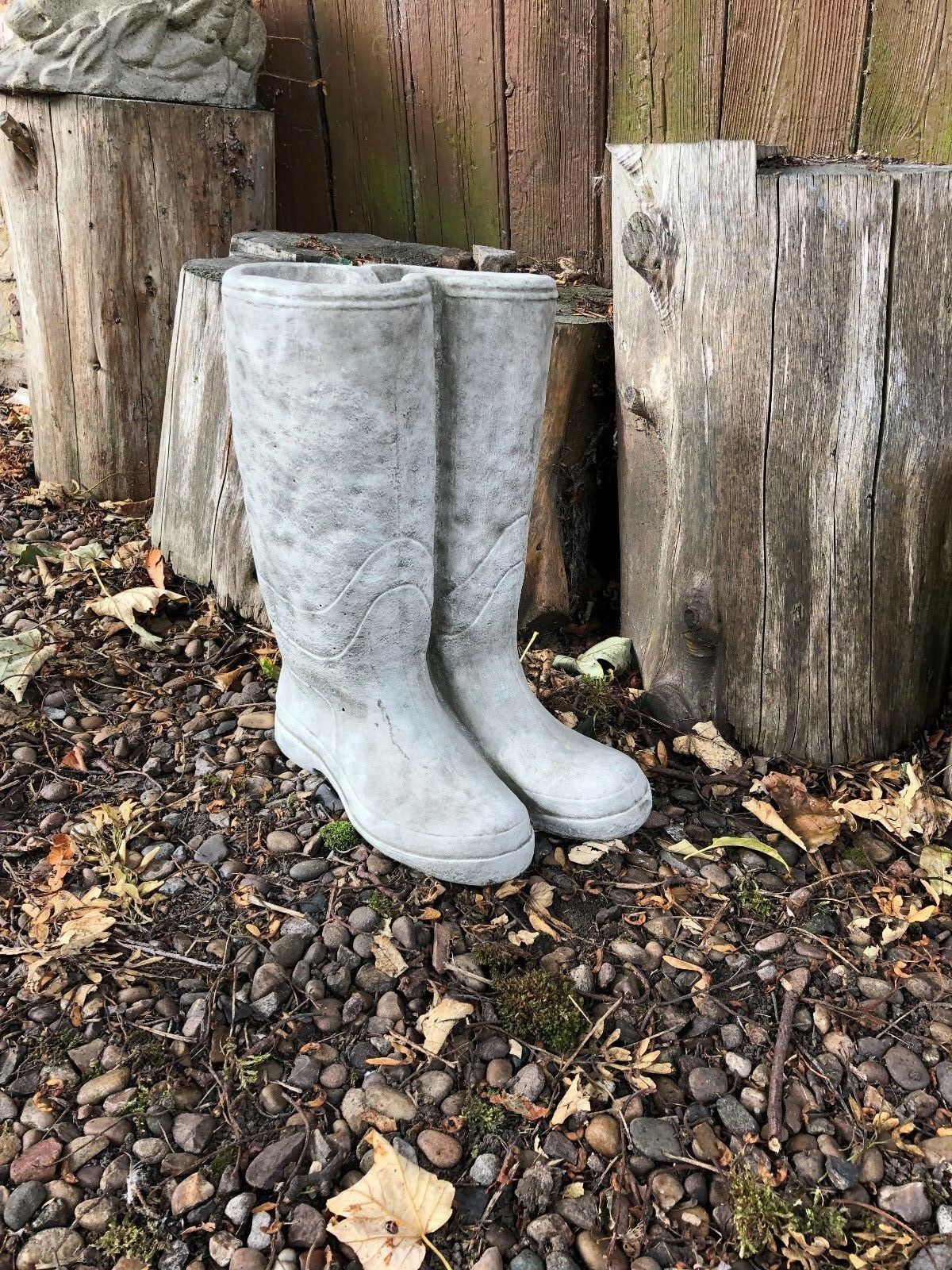 Handmade Stone Wellington Boots Planter with antique stone finish, set against a natural garden backdrop for outdoor plant styling.