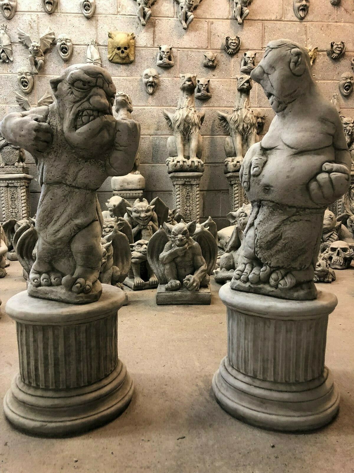 Bare Knuckle Boxer Statues - Garden Ornaments in stone finish, featuring two muscular cartoonish fighters on plinths, ideal for outdoor decor.