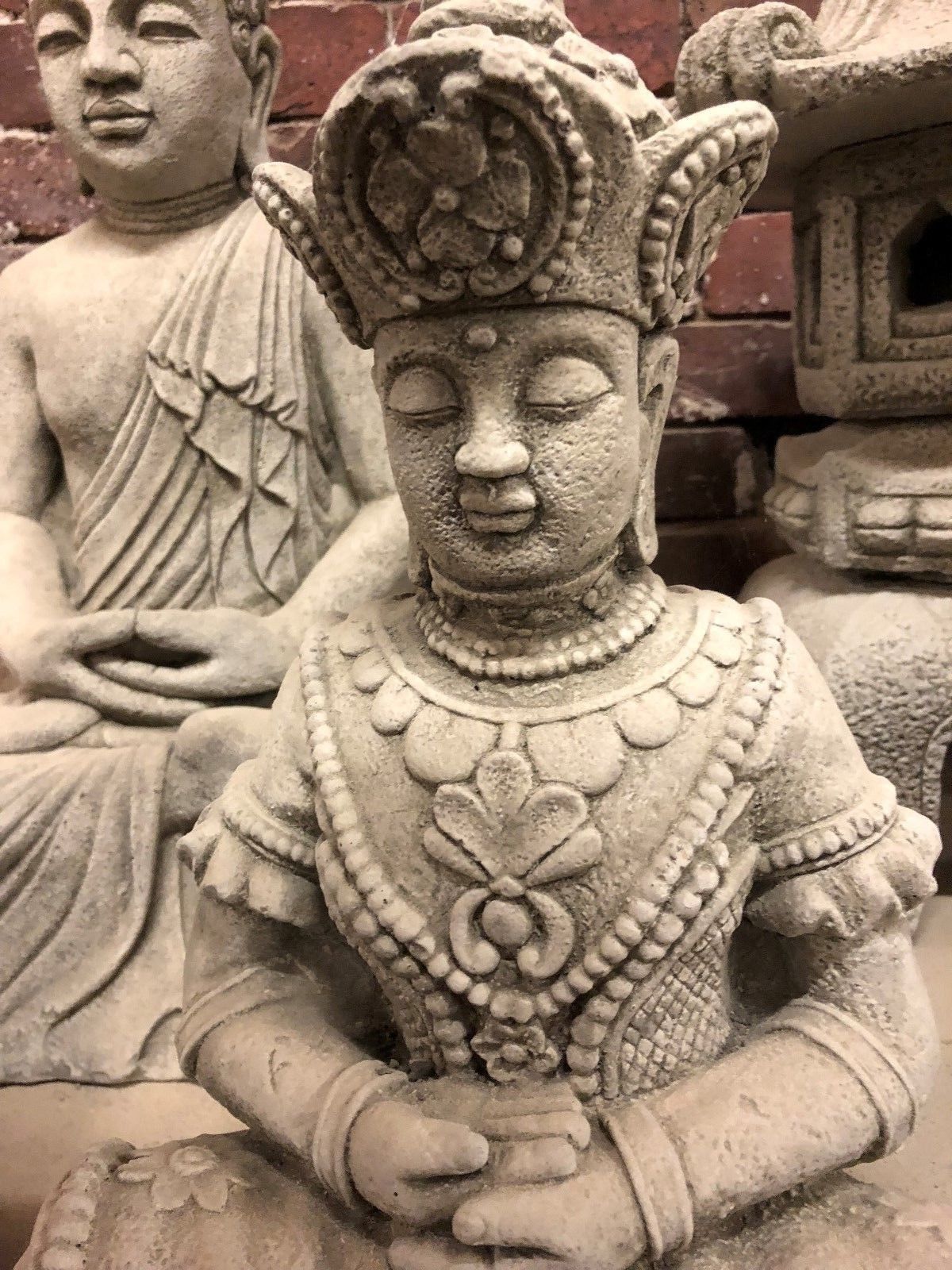 Serene Buddha Statue Garden - Meditating Stone | Peaceful Decor. Detailed chest and face view of limestone Buddha statue, symbolizing peace and mindfulness.