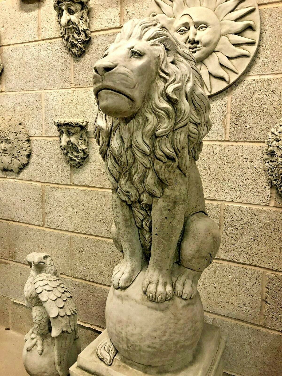 Front-facing stone lion statue with regal posture and flowing mane, crafted from solid limestone for durable garden ornamentation.