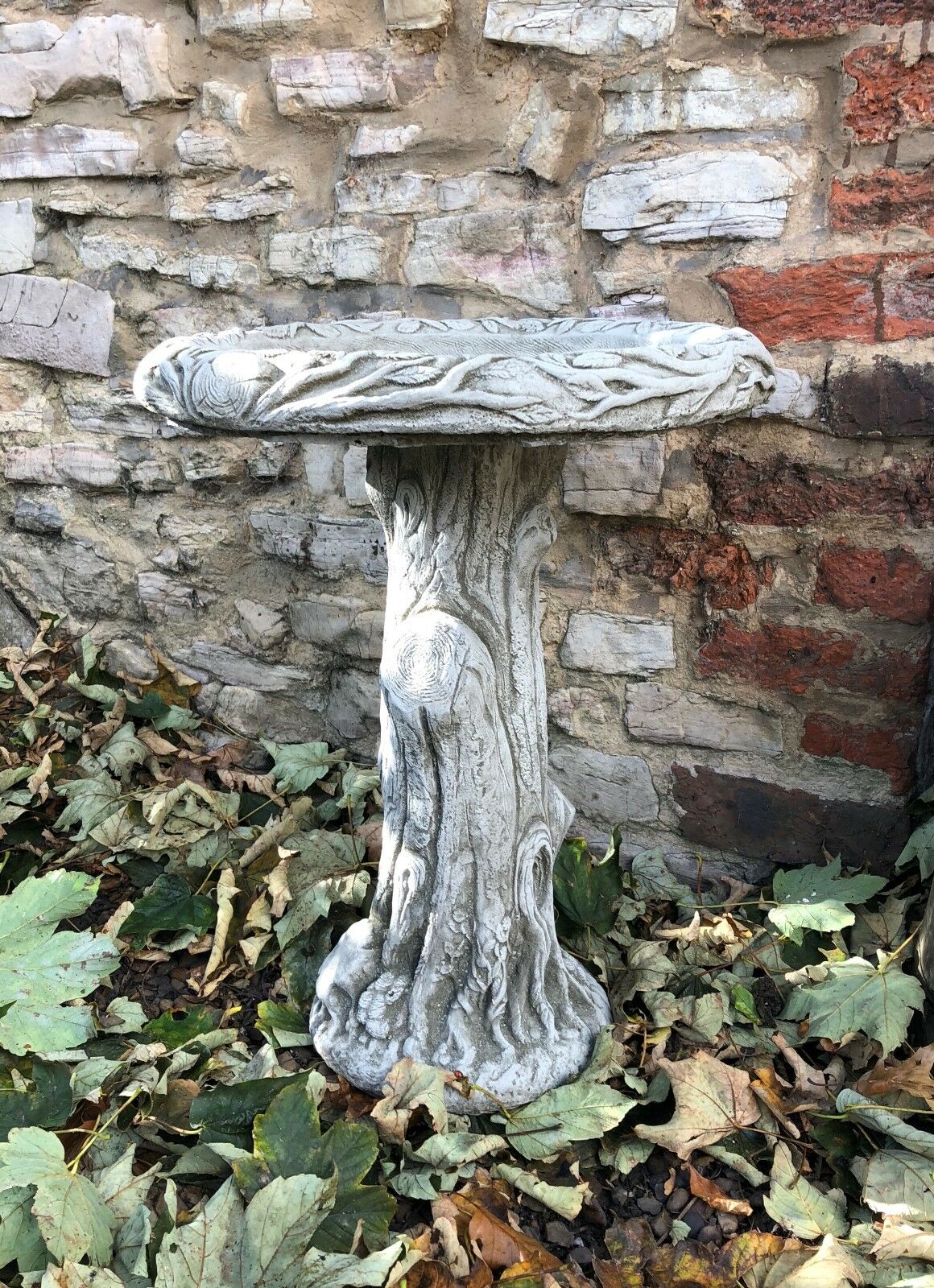 Stone Garden Bird Bath with lifelike tree trunk base and wide basin, a stunning outdoor ornament for patios and lawns.