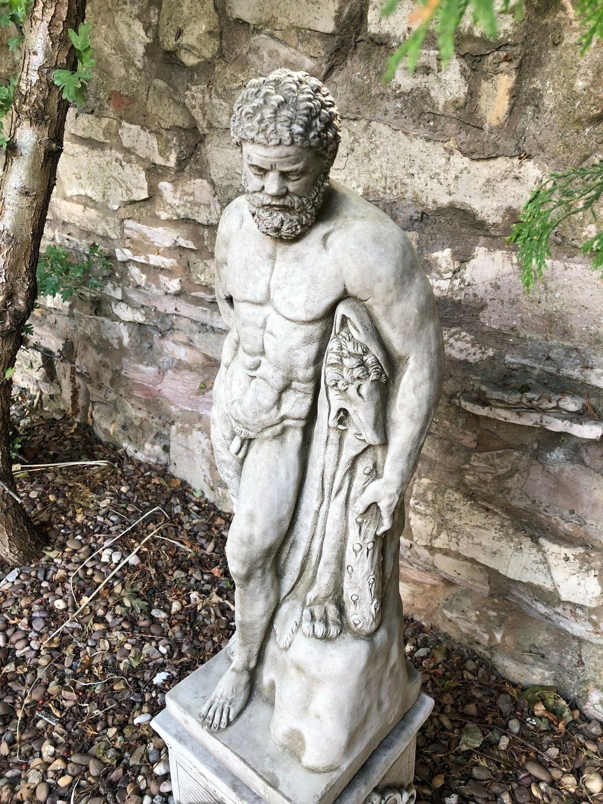 Angled top view of Hercules garden sculpture showing muscular torso and lion skin, ideal for classical outdoor decor.