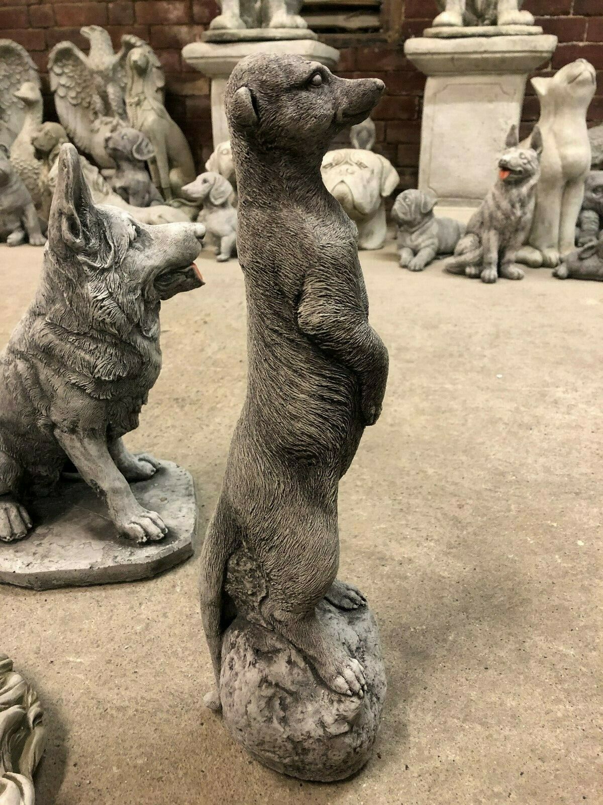Detailed side view of a stone meerkat ornament in a showroom, perfect for patios or garden landscapes.