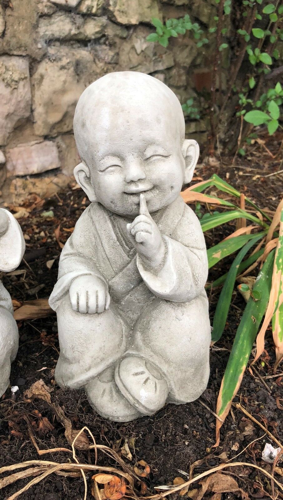 Zoomed-in 'Speak No Evil' Baby Monk Ornament with finger over lips, stone sculpture perfect for zen garden aesthetics.