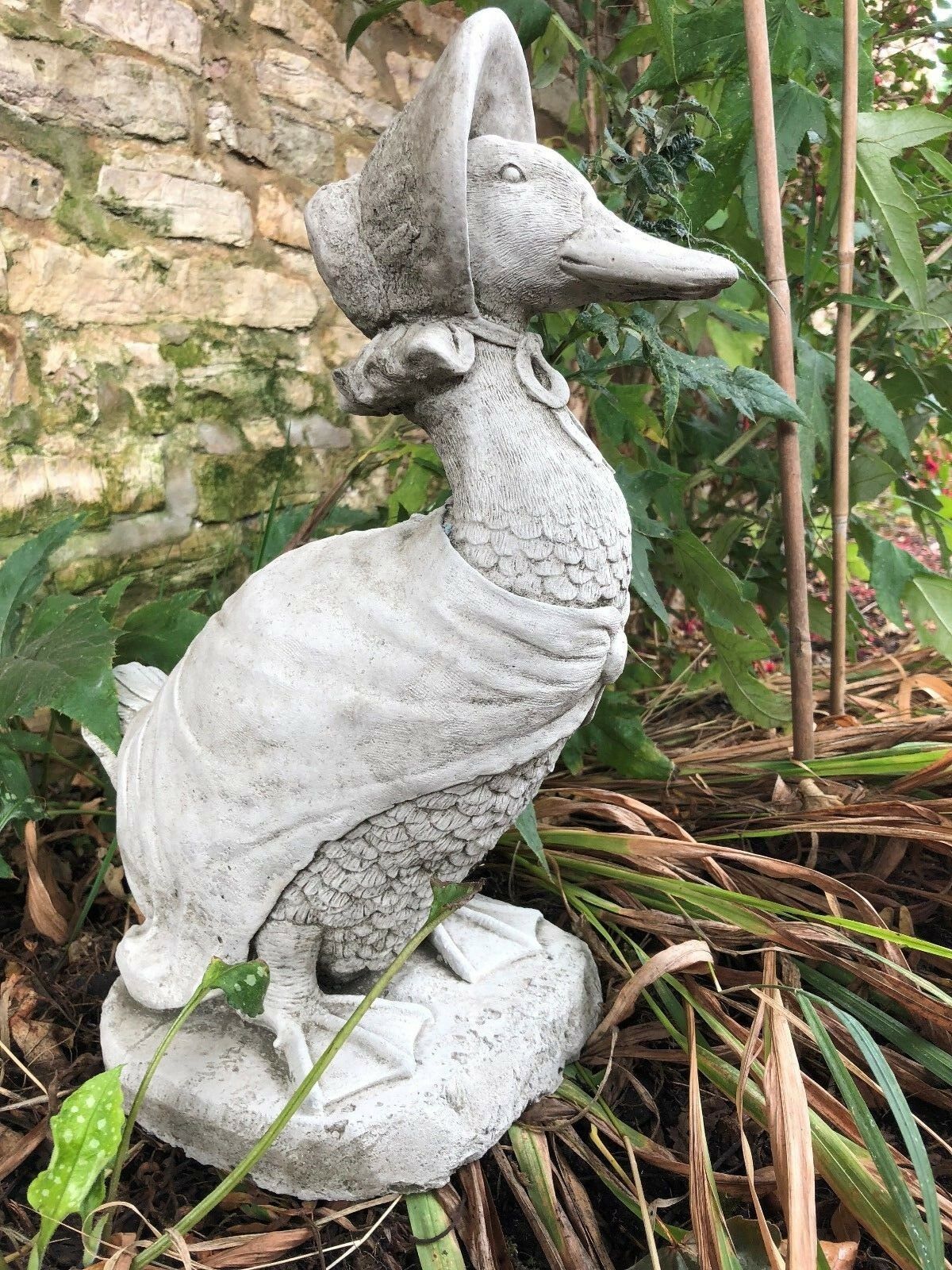 Profile view of Jemima Duck stone ornament showing detailed feathers and bonnet. A classic garden sculpture for outdoor decor.