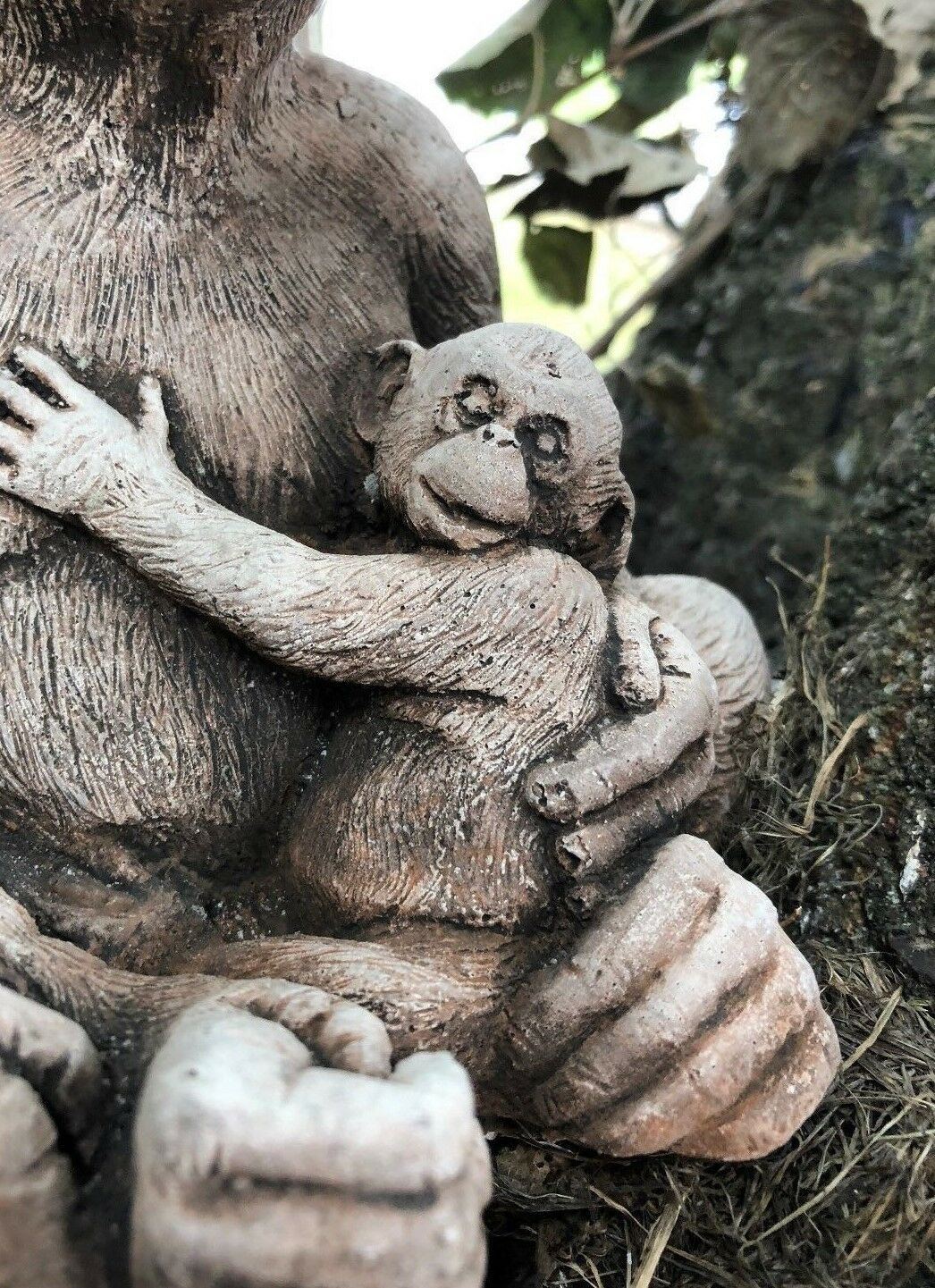 Close-up of baby monkey hugging mother in Stone Monkey Garden Ornament, showcasing fine limestone texture and emotional detail.