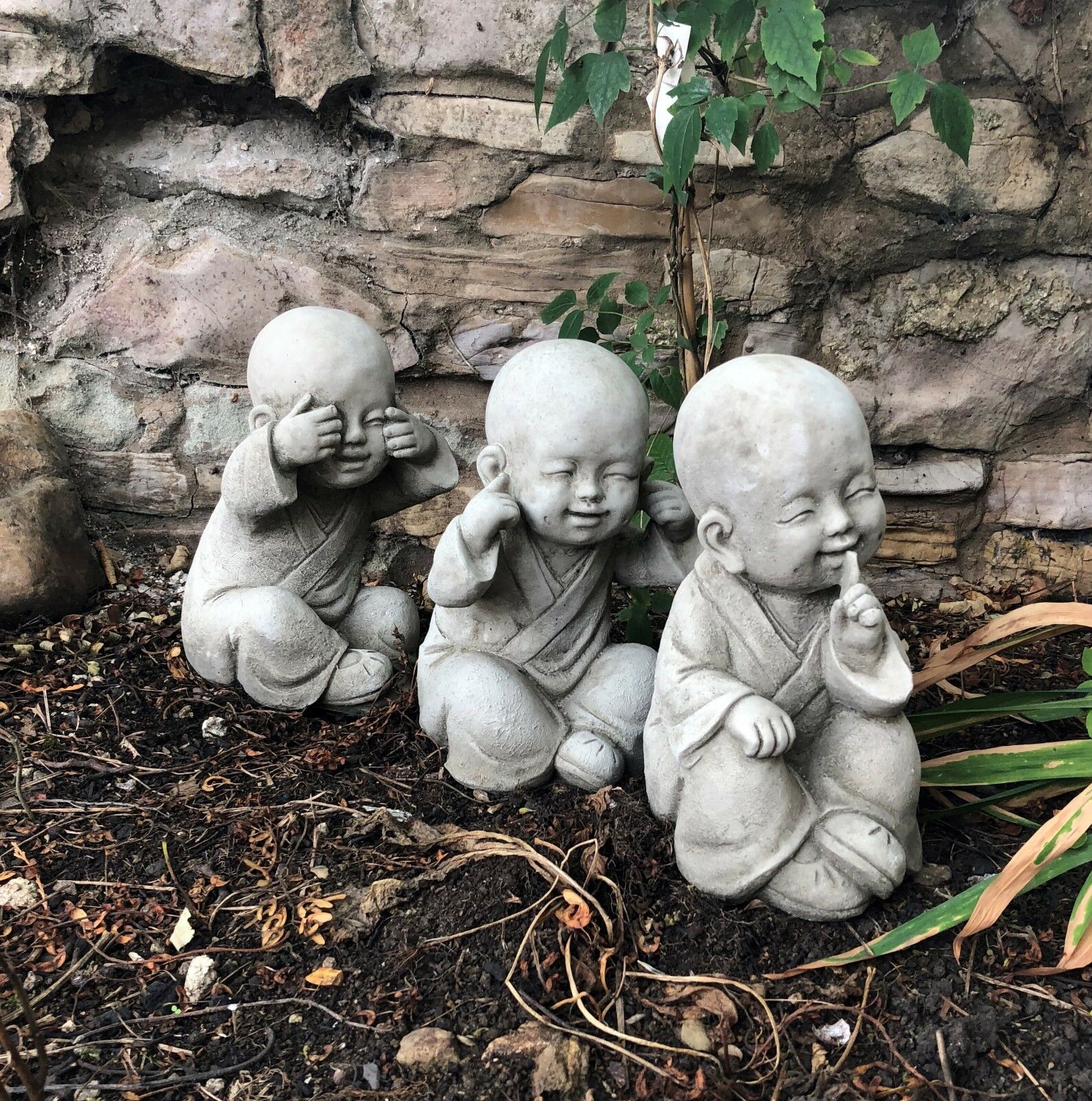 Angled front view of Baby Monk Ornaments Set - See, Hear, Speak No Evil, enhancing garden charm with antique stone detail.
